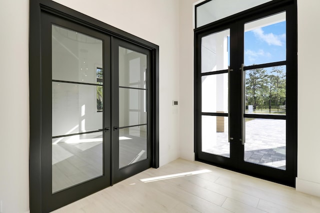 entryway featuring french doors and light hardwood / wood-style flooring