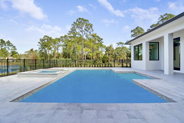 view of pool featuring a patio area and an in ground hot tub