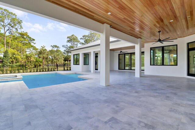 view of pool with ceiling fan and a patio