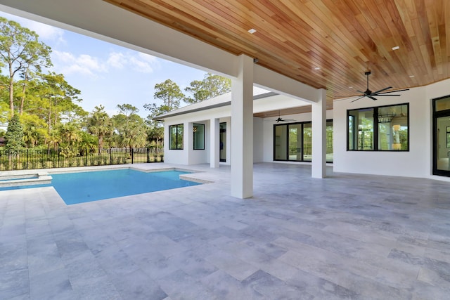 view of swimming pool featuring ceiling fan and a patio area