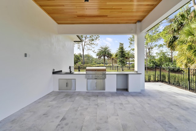 view of patio / terrace featuring exterior kitchen, sink, and grilling area