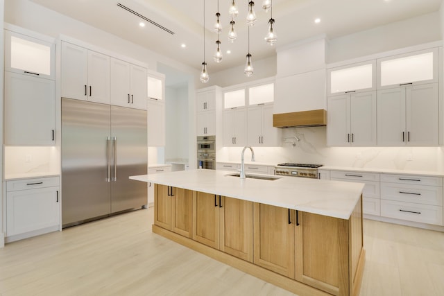 kitchen with stainless steel appliances, a large island, and white cabinets