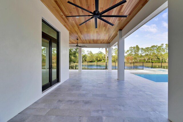 view of patio / terrace featuring ceiling fan, a fenced in pool, and a water view