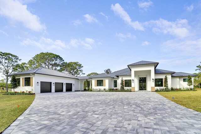 view of front of house featuring a garage and a front yard