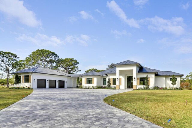 view of front of home with a garage and a front yard