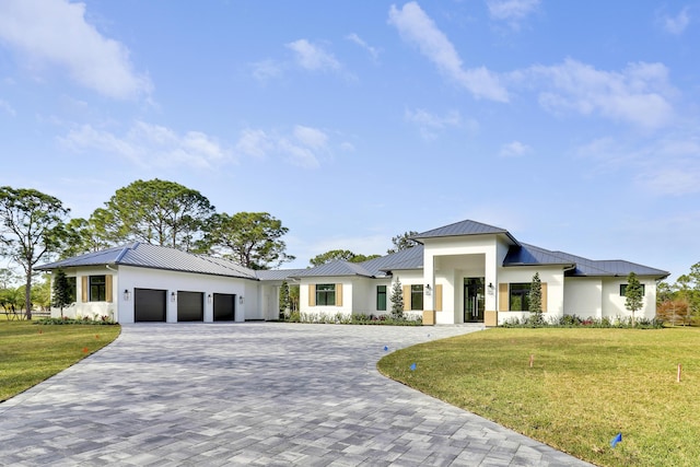 view of front of property with a garage and a front lawn