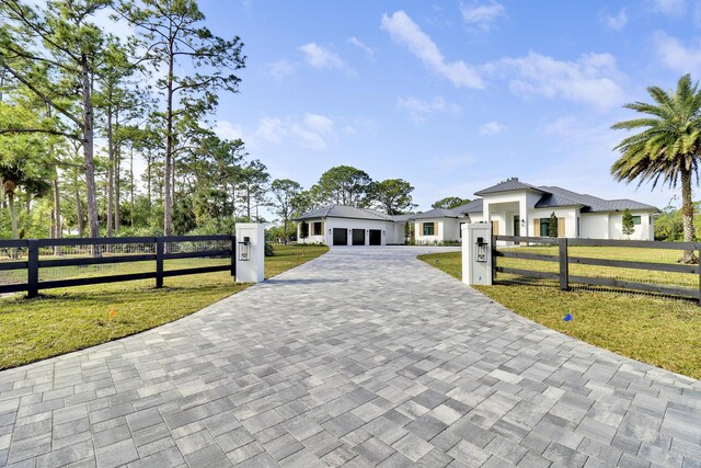 view of front of home with a front lawn and a garage