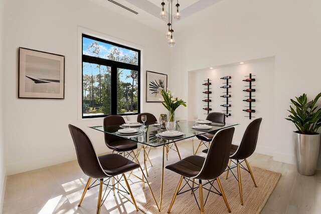 dining area with a towering ceiling