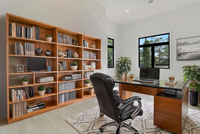 home office with light hardwood / wood-style floors