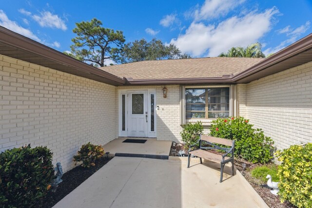 view of exterior entry featuring a patio