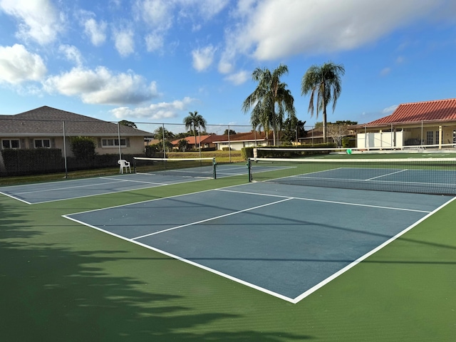 view of tennis court featuring fence