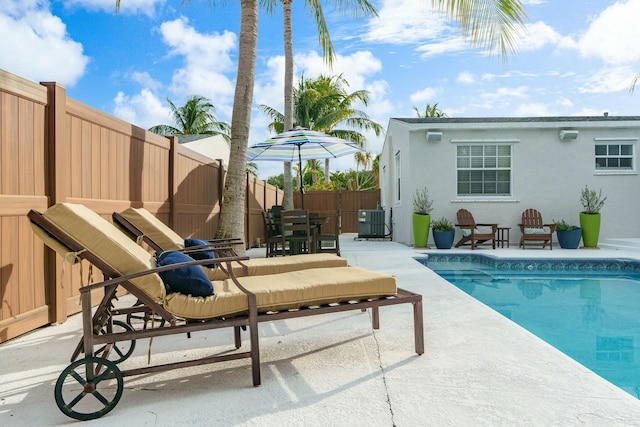 view of pool featuring a patio and central AC unit