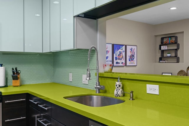 kitchen featuring decorative backsplash, white cabinetry, and sink