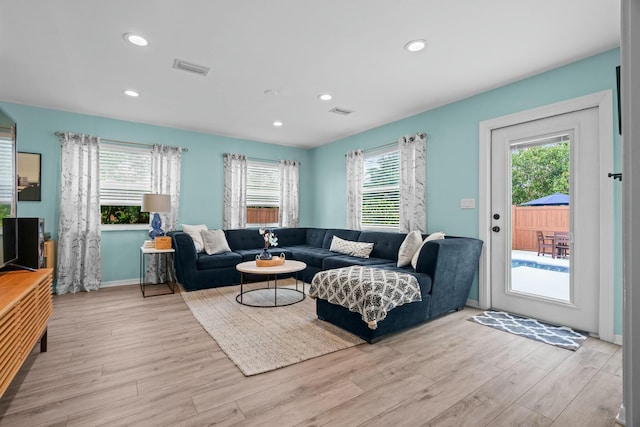 living room featuring light hardwood / wood-style flooring and a wealth of natural light