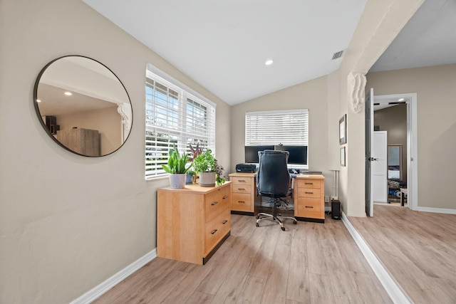 office with lofted ceiling and light wood-type flooring