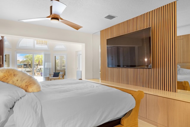 bedroom with a textured ceiling and ceiling fan