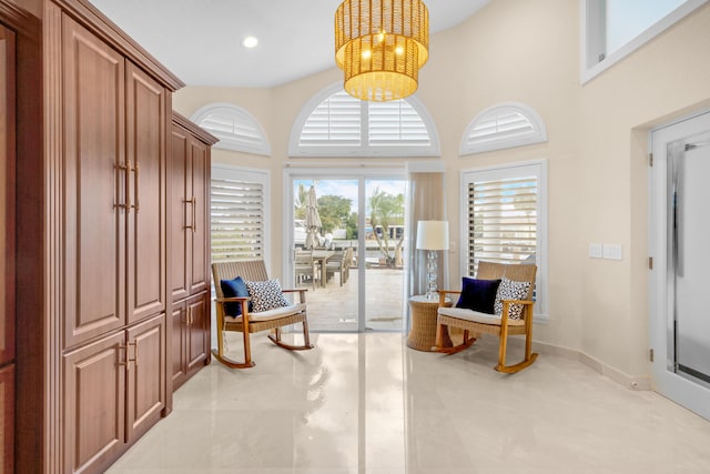 living area with a high ceiling and a chandelier