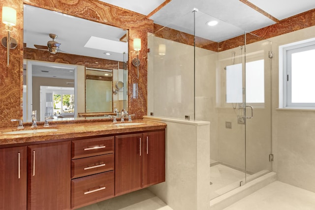 bathroom featuring vanity, an enclosed shower, and ceiling fan