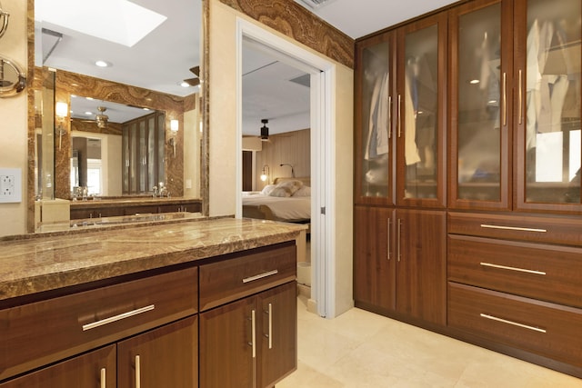 bathroom featuring a skylight and vanity