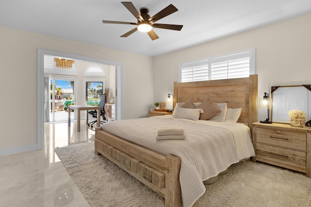 bedroom featuring ceiling fan and multiple windows