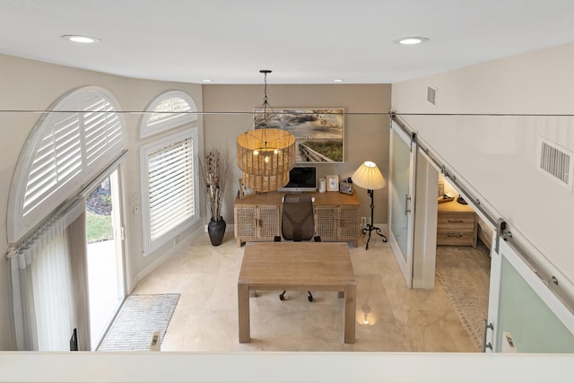 interior space with a barn door and vaulted ceiling