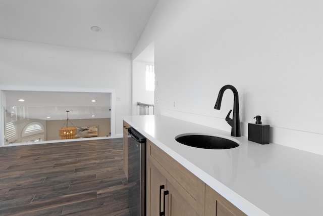 kitchen featuring wine cooler, sink, decorative light fixtures, and dark hardwood / wood-style floors