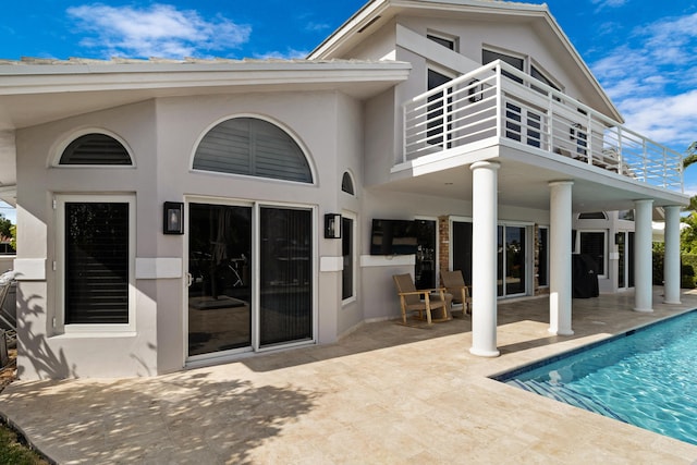 back of house featuring a patio and a balcony