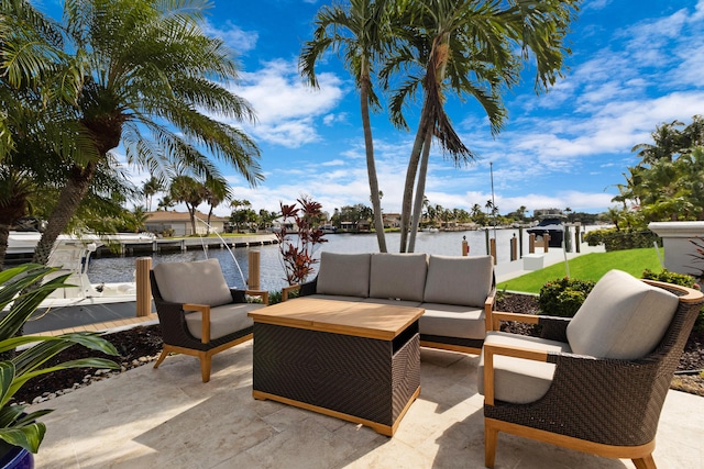 view of patio / terrace with outdoor lounge area, a boat dock, and a water view