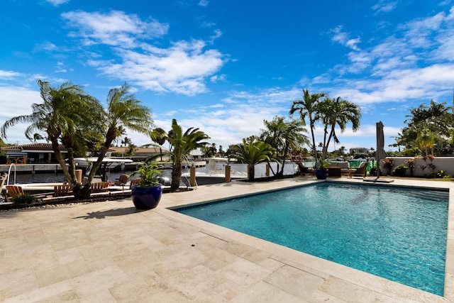 view of swimming pool featuring a patio area