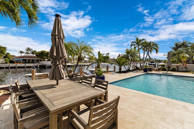 view of swimming pool featuring a water view and a patio area