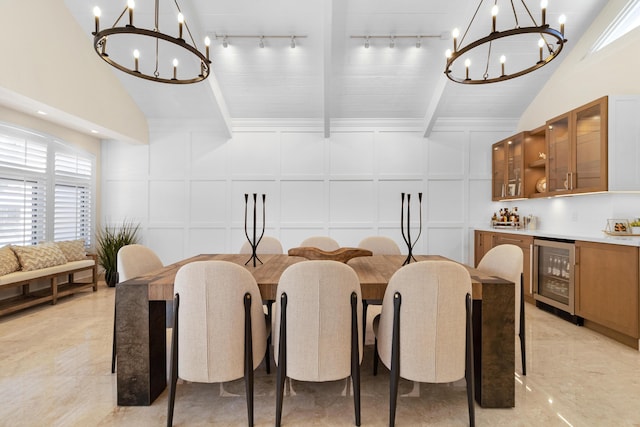 dining room with a chandelier, lofted ceiling with beams, and wine cooler