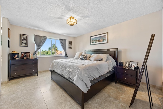 tiled bedroom featuring a textured ceiling