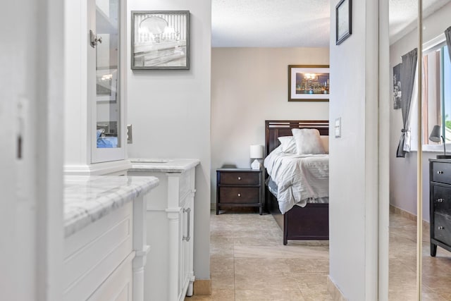 tiled bedroom featuring a textured ceiling