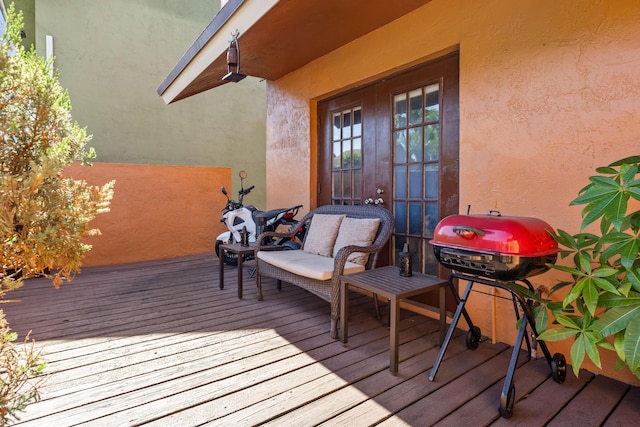 wooden terrace featuring a grill