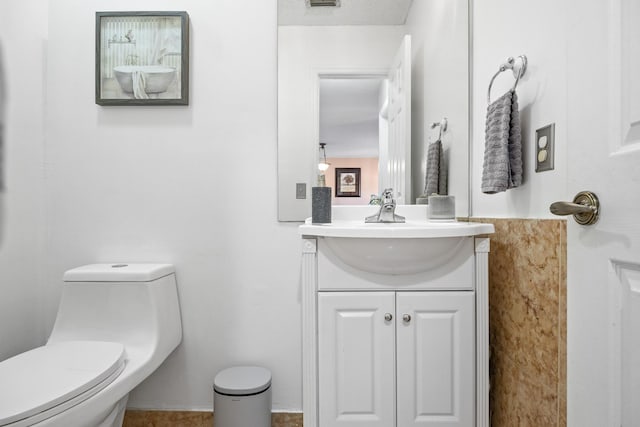 bathroom featuring vanity, toilet, and a textured ceiling