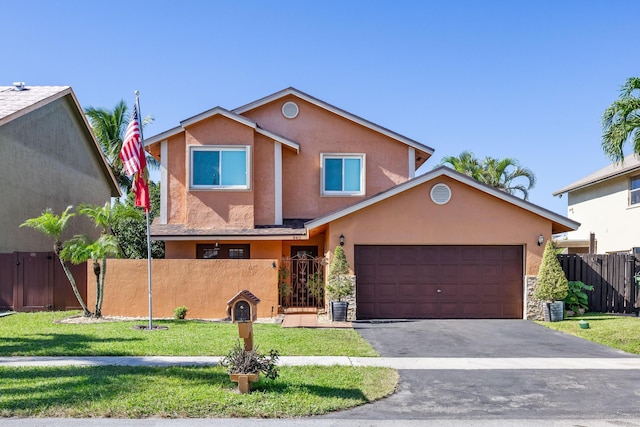 view of front of property featuring a garage and a front lawn