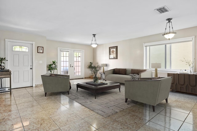 tiled living room featuring french doors