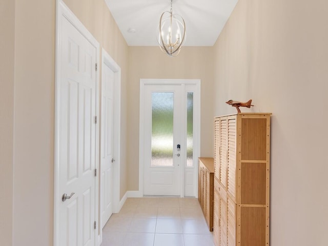 entryway with light tile patterned floors and a notable chandelier