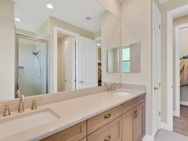 bathroom featuring vanity, an enclosed shower, and hardwood / wood-style flooring