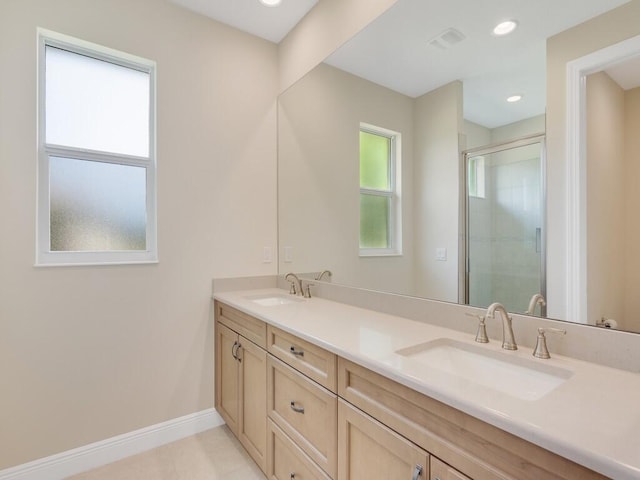 bathroom featuring tile patterned floors, vanity, and walk in shower