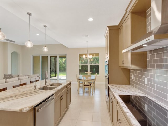 kitchen with tasteful backsplash, stainless steel dishwasher, wall chimney exhaust hood, sink, and decorative light fixtures