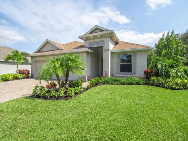 view of front facade with a front yard and a garage