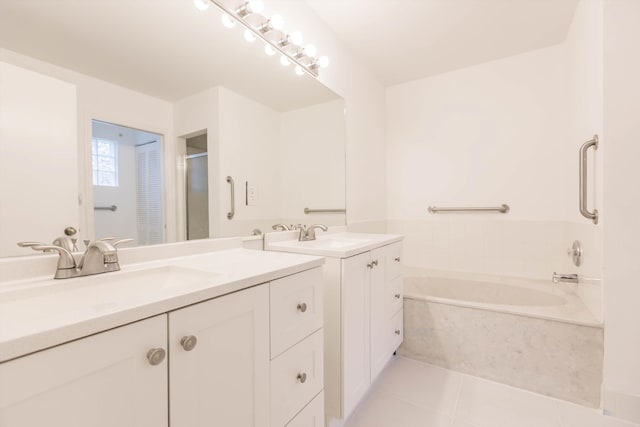 bathroom with tile patterned flooring, vanity, and shower with separate bathtub