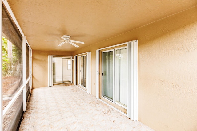 unfurnished sunroom with a wealth of natural light and ceiling fan