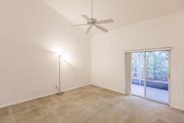 spare room with light carpet, high vaulted ceiling, and ceiling fan