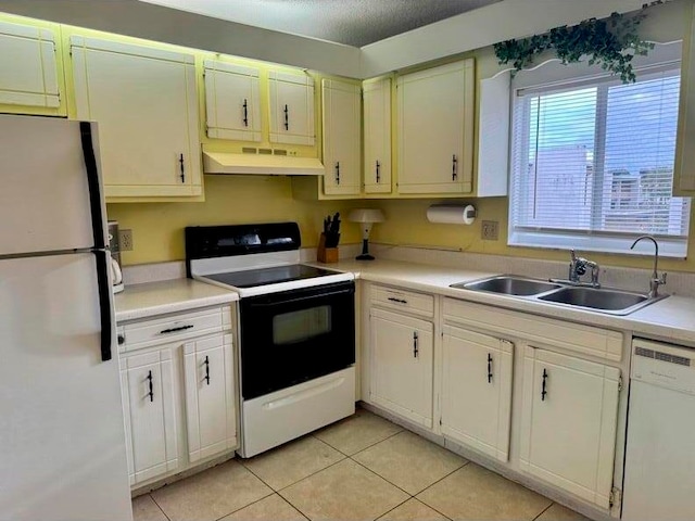 kitchen featuring white cabinetry, sink, a textured ceiling, white appliances, and light tile patterned flooring