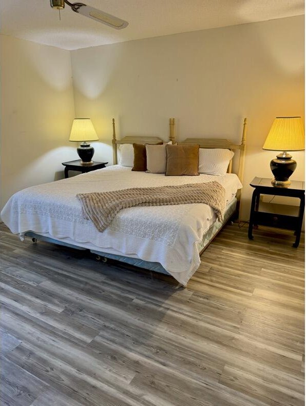 bedroom featuring hardwood / wood-style flooring and ceiling fan