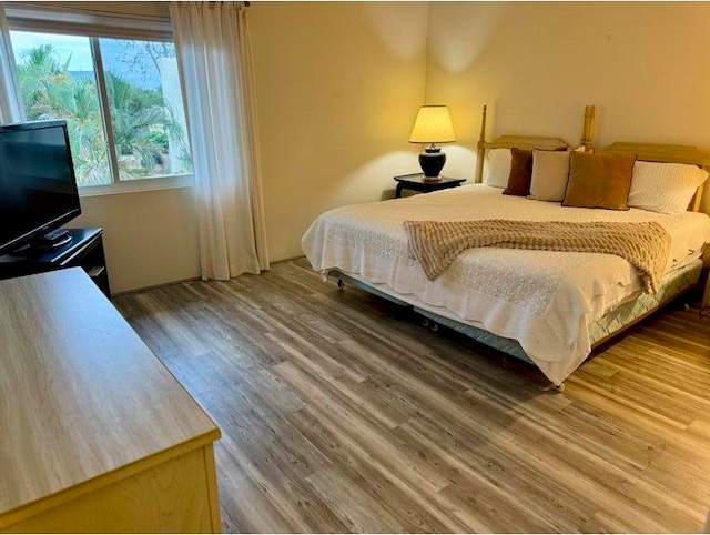 bedroom with hardwood / wood-style floors