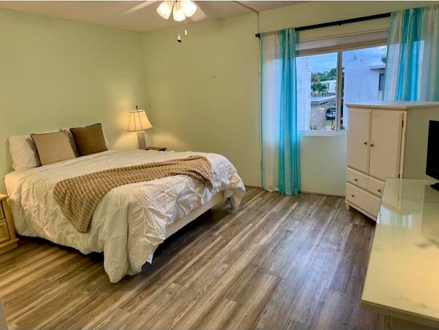 bedroom featuring ceiling fan and wood-type flooring