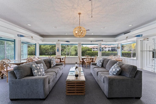 living room featuring dark carpet and a textured ceiling